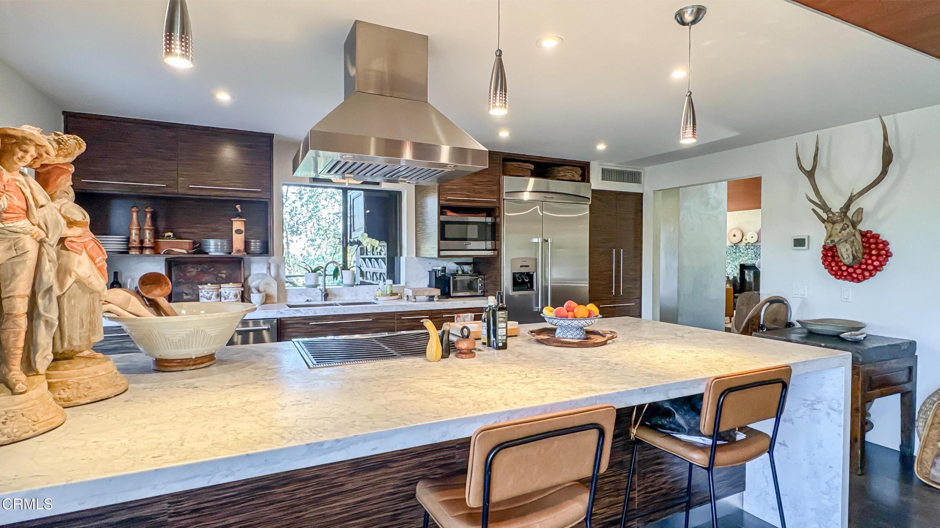 1344 Marianna Road Pasadena, CA 91105 - Photo 14 of 38 a view of a dining room with furniture a chandelier and wooden floor