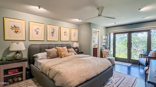 a bedroom with a large bed and a chandelier
