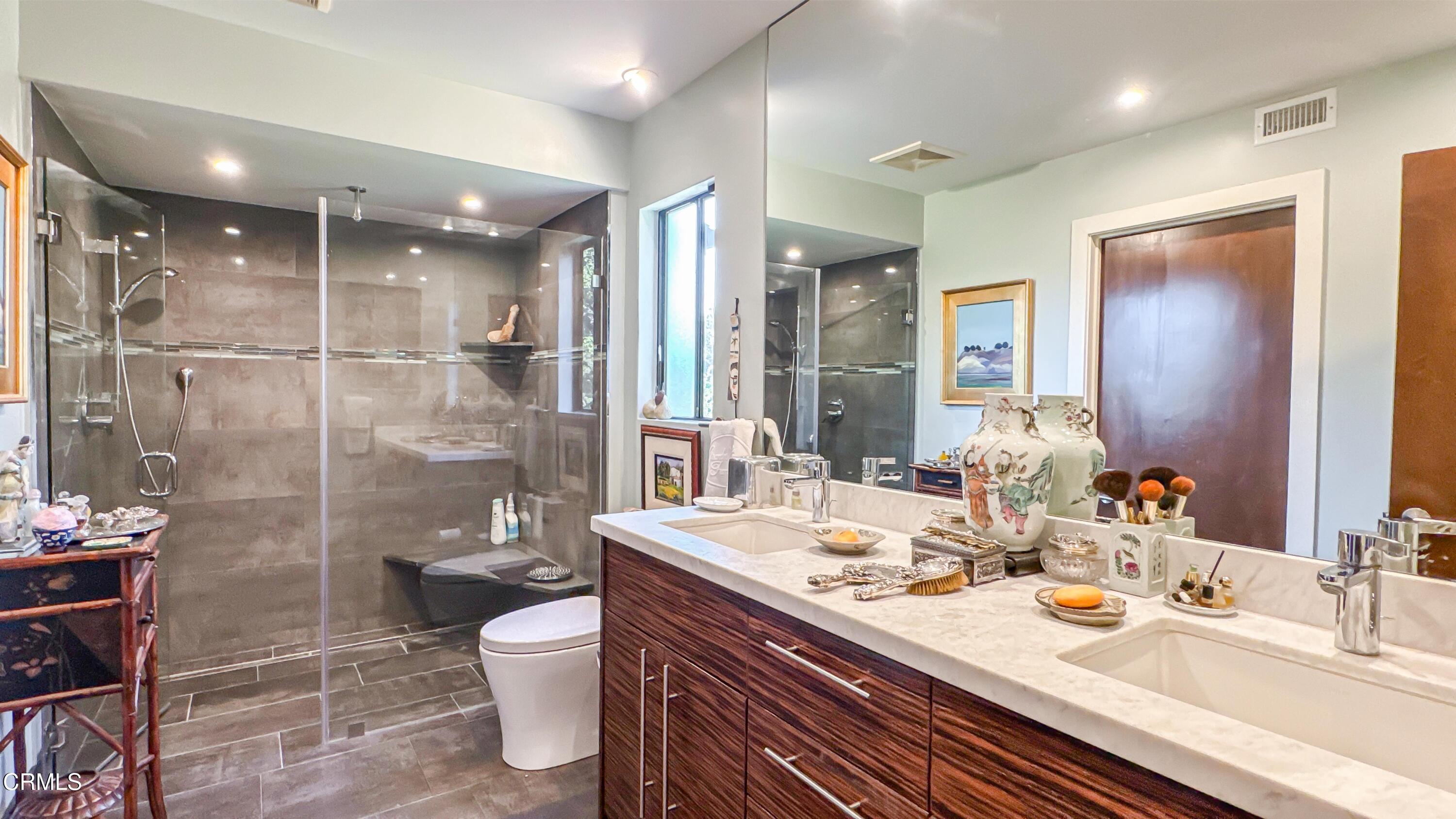 1344 Marianna Road Pasadena, CA 91105 - Photo 20 of 38 a bathroom with a granite countertop sink a toilet a mirror and shower