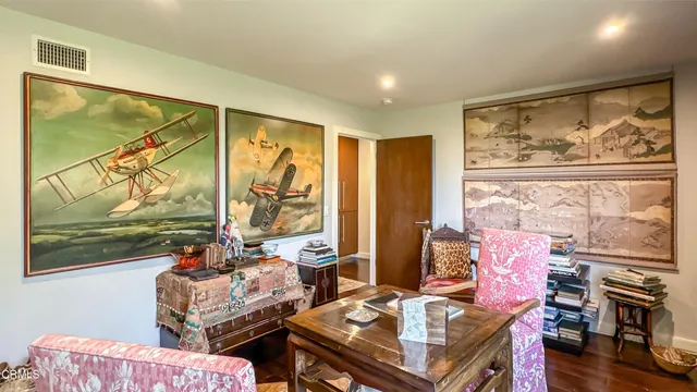 a living room with furniture and a book shelf