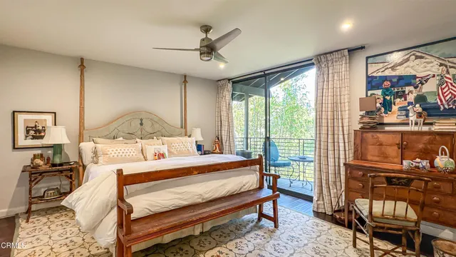 a bedroom with a large bed and a large window