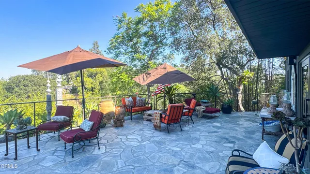 a outdoor space with lots of furniture and umbrella