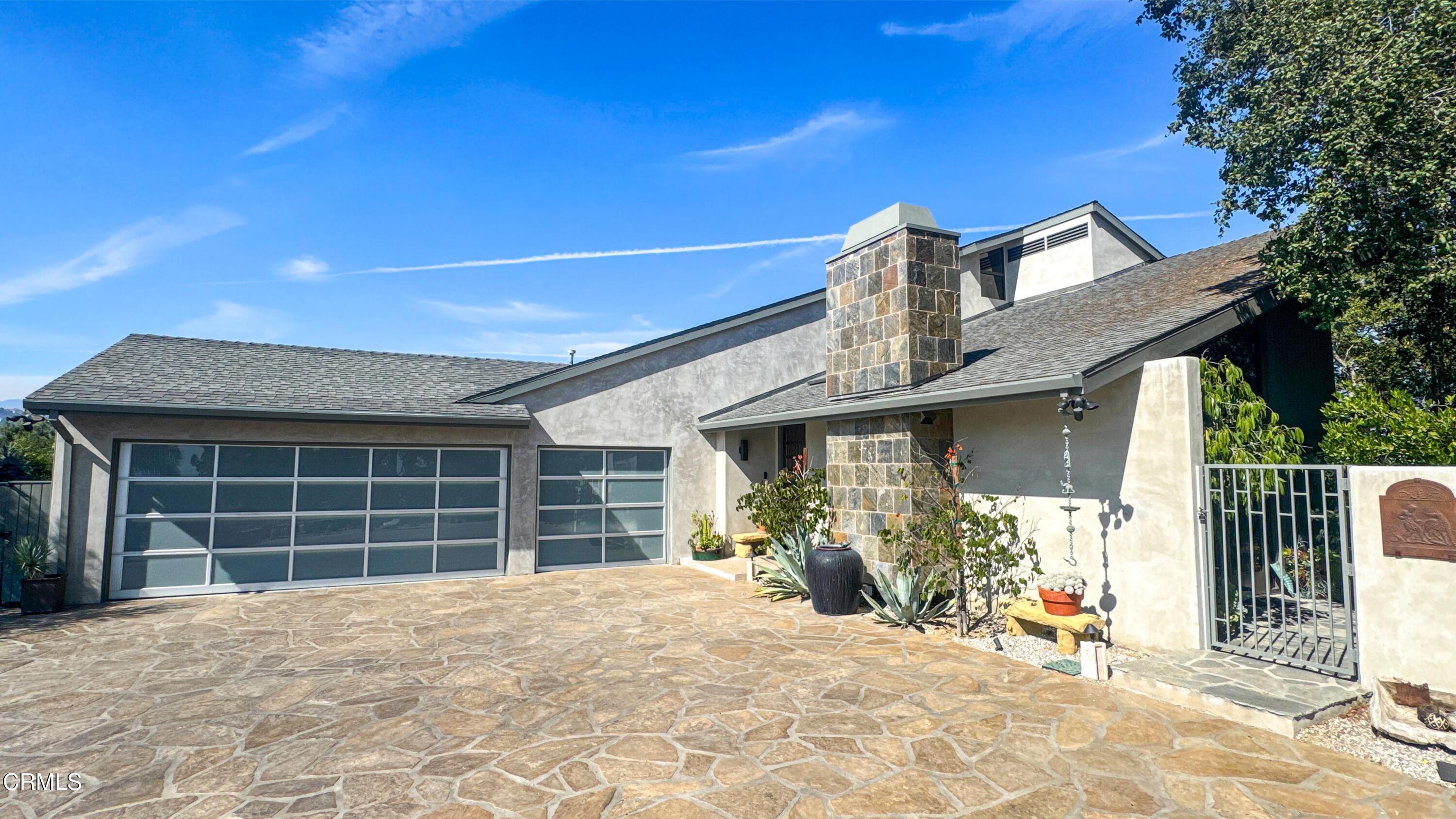 1344 Marianna Road Pasadena, CA 91105 - Photo 3 of 38 a view of a house with wooden walls and a large tree