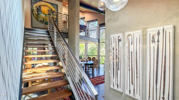 a view of entryway with wooden floor and windows