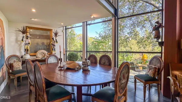 a dining room with furniture a window and a view