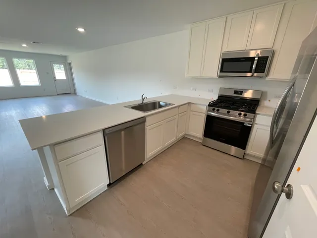 a kitchen with a sink and a stove top oven