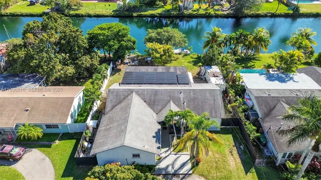 an aerial view of a house with a lake view