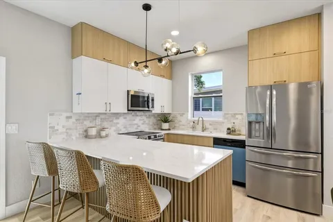 a kitchen with a refrigerator a sink and a stove