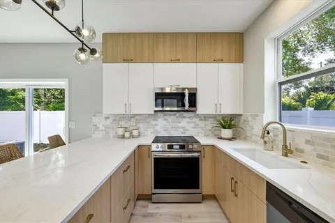 a kitchen with a sink stove and microwave