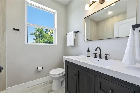 a bathroom with a toilet sink and mirror