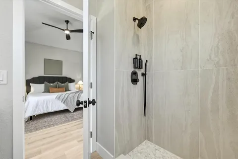 a bedroom with a bed and a wooden floor