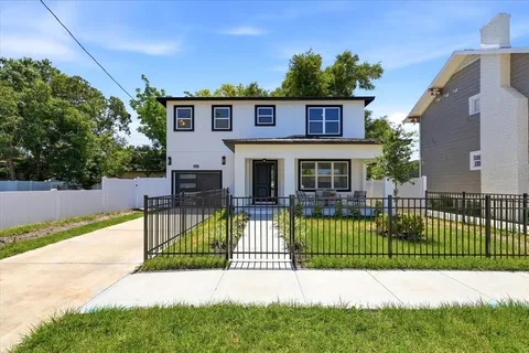 a view of a house with a small yard and plants