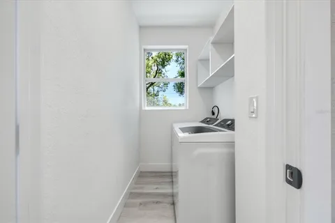 a utility room with sink dryer and washer