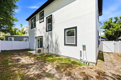 a view of a house with backyard and tree