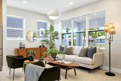 a living room with furniture and a large window