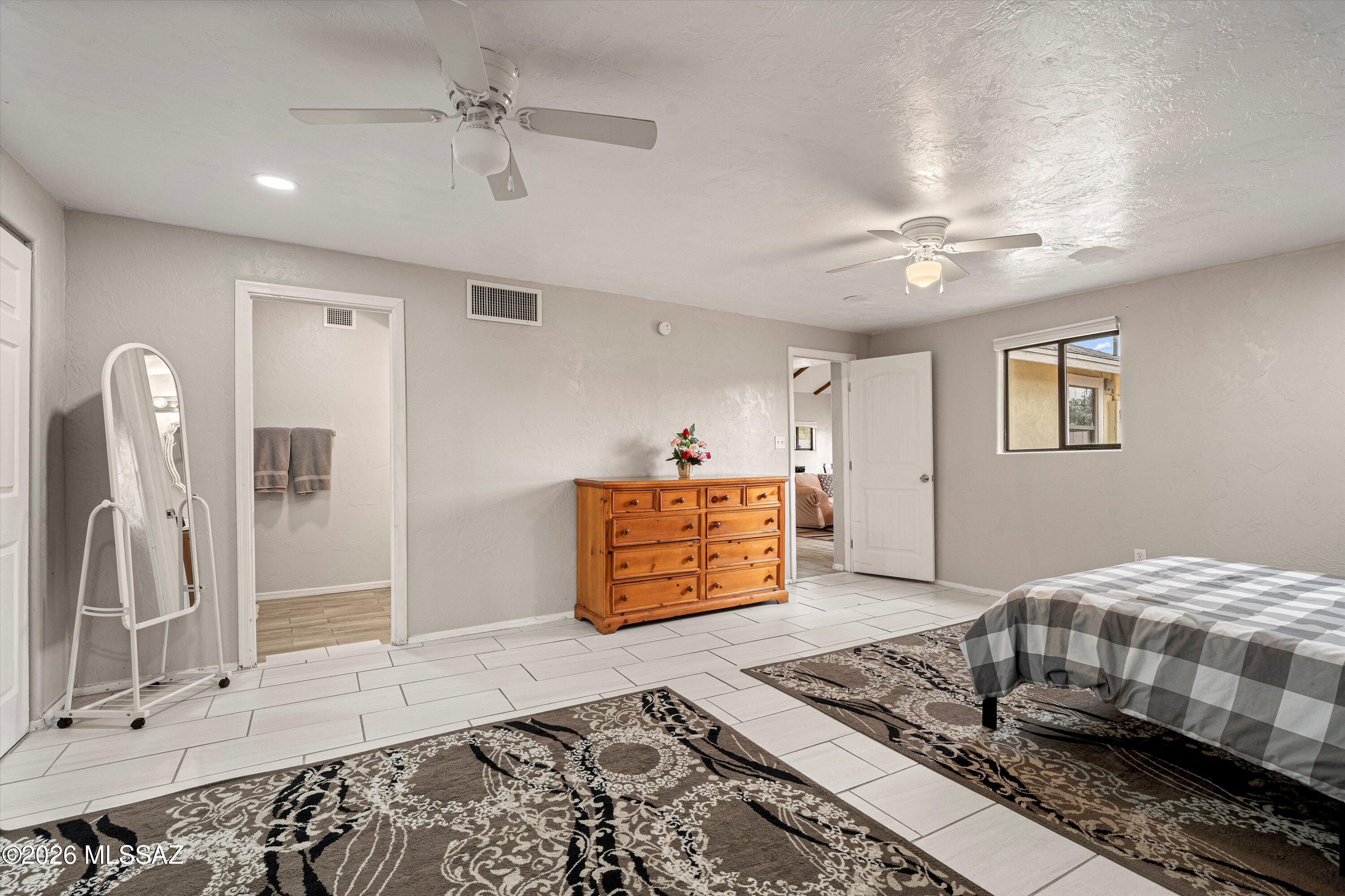 2841 North Richey Boulevard Tucson, AZ 85716 - Photo 16 of 30 a bedroom with a bed and a chandelier