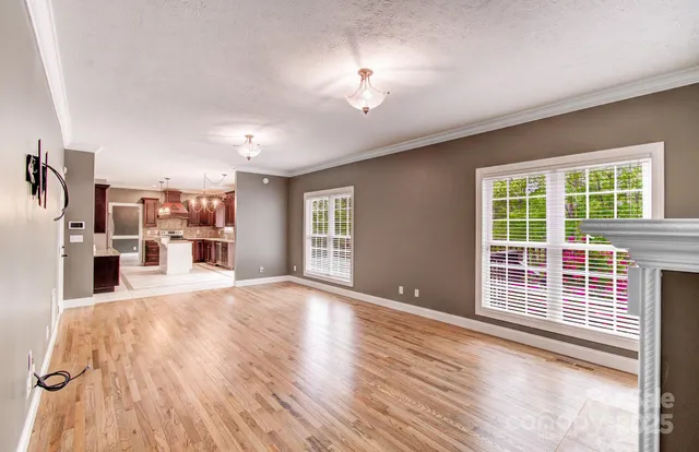 a view of a livingroom with furniture wooden floor and a window