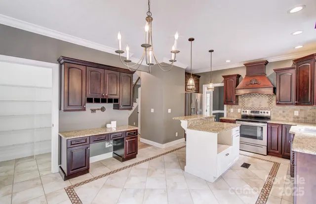 a kitchen with stainless steel appliances granite countertop a sink a stove and a refrigerator