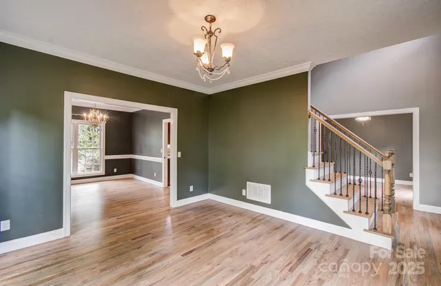 a view of a hallway view with wooden floor and staircase