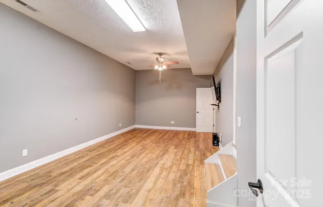 a view of a room with a wooden floor