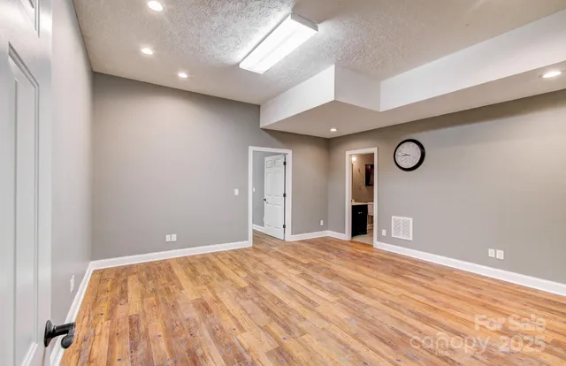 a view of an empty room with wooden floor