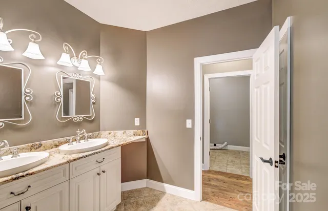 a bathroom with a double vanity sink and a mirror
