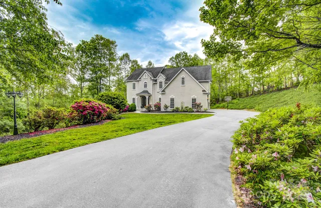 a view of a house with a yard and garage