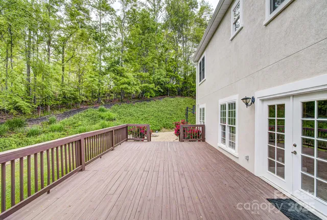 a view of a deck with couches with wooden floor and fence