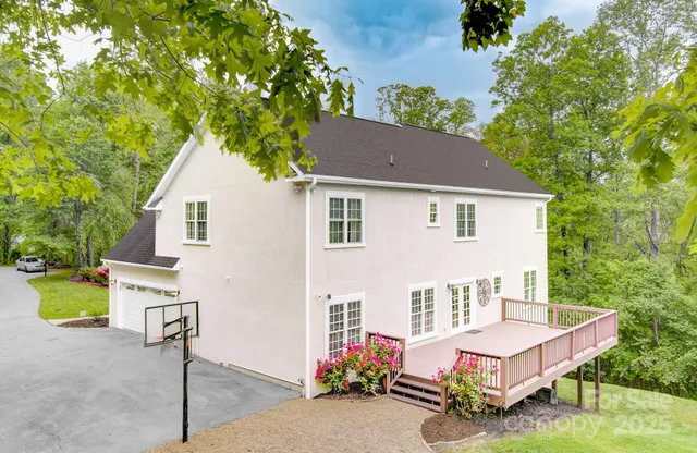 a view of a house with a patio and a yard