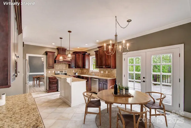 a kitchen with refrigerator and chairs