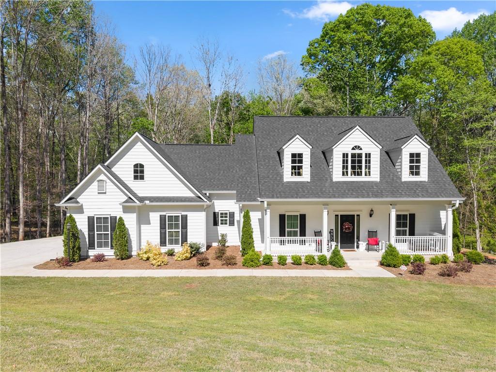 a front view of a house with swimming pool having outdoor seating