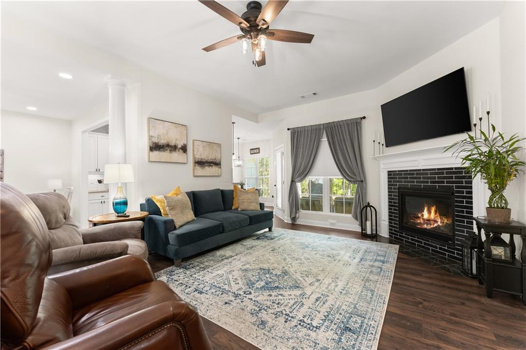 179 Prime Drive Commerce, GA 30530 - Photo 17 of 44 a living room with furniture a fireplace and a flat screen tv
