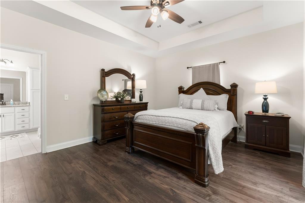 179 Prime Drive Commerce, GA 30530 - Photo 21 of 44 a bedroom with a bed and a chandelier
