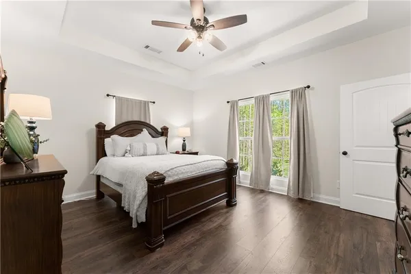 a bedroom with a bed and a potted plant