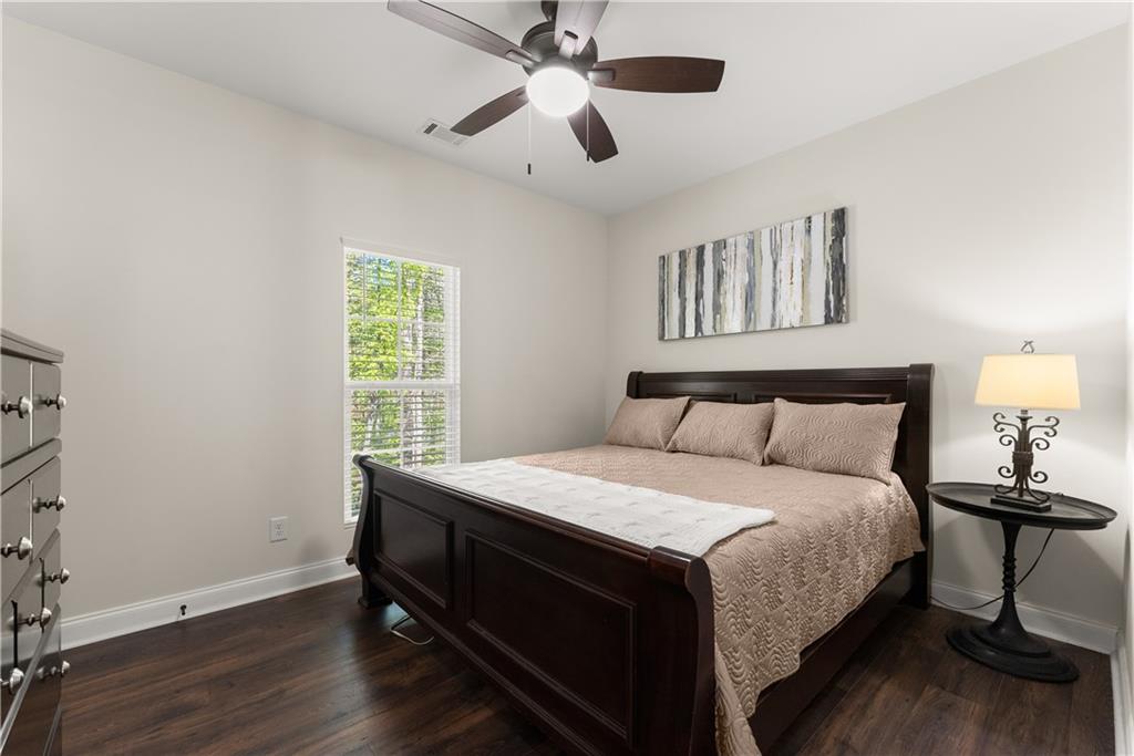 179 Prime Drive Commerce, GA 30530 - Photo 29 of 44 a bedroom with a bed and a chandelier