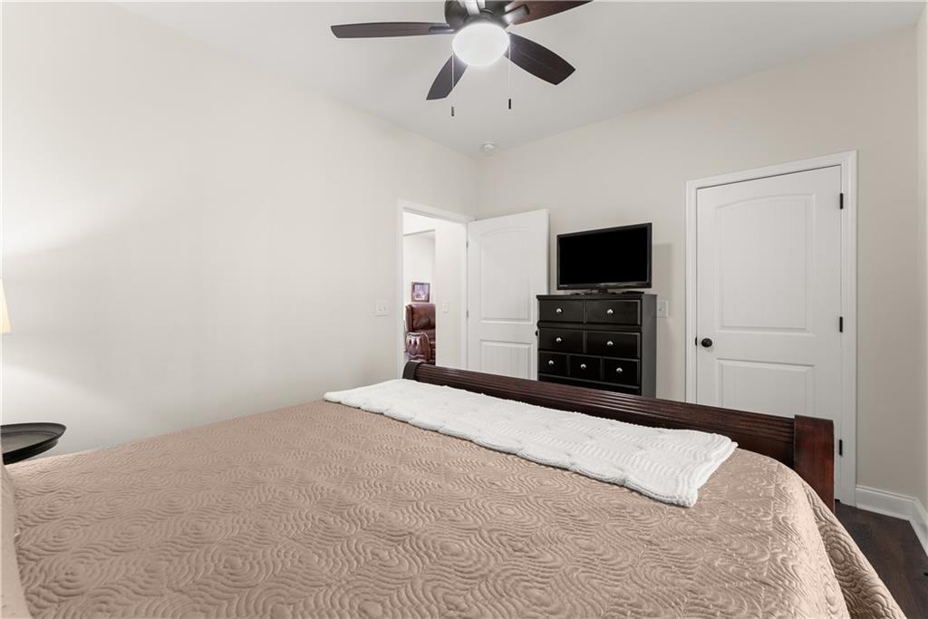 179 Prime Drive Commerce, GA 30530 - Photo 30 of 44 a bedroom with a bed and a flat tv screen on dresser