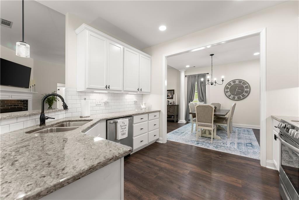 179 Prime Drive Commerce, GA 30530 - Photo 9 of 44 a kitchen with granite countertop a sink cabinets and stainless steel appliances