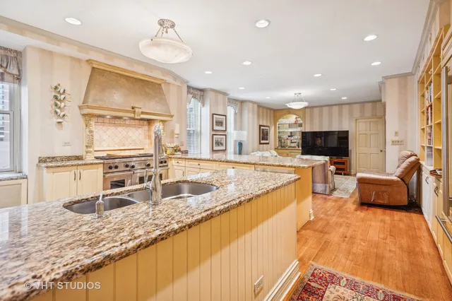 a large kitchen with granite countertop lots of counter space sink and a granite counter tops