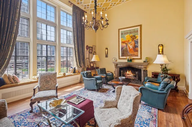 a living room with furniture fireplace and a large window