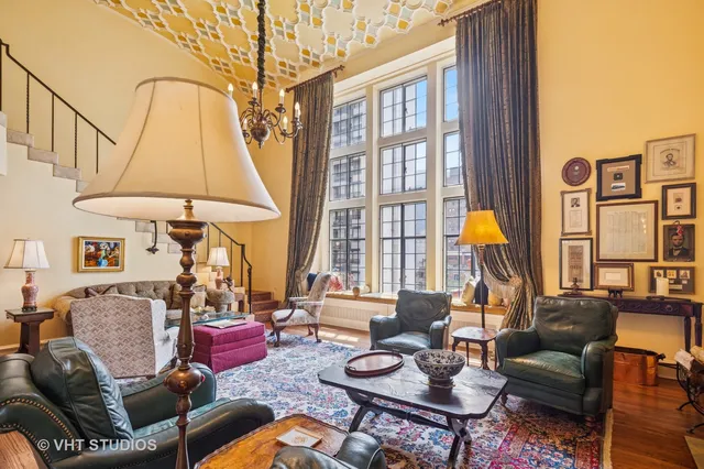 a living room with furniture a window and a table