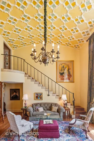 a living room with furniture and a chandelier