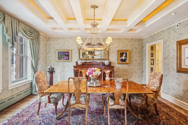 a view of a dining room with furniture a chandelier and wooden floor