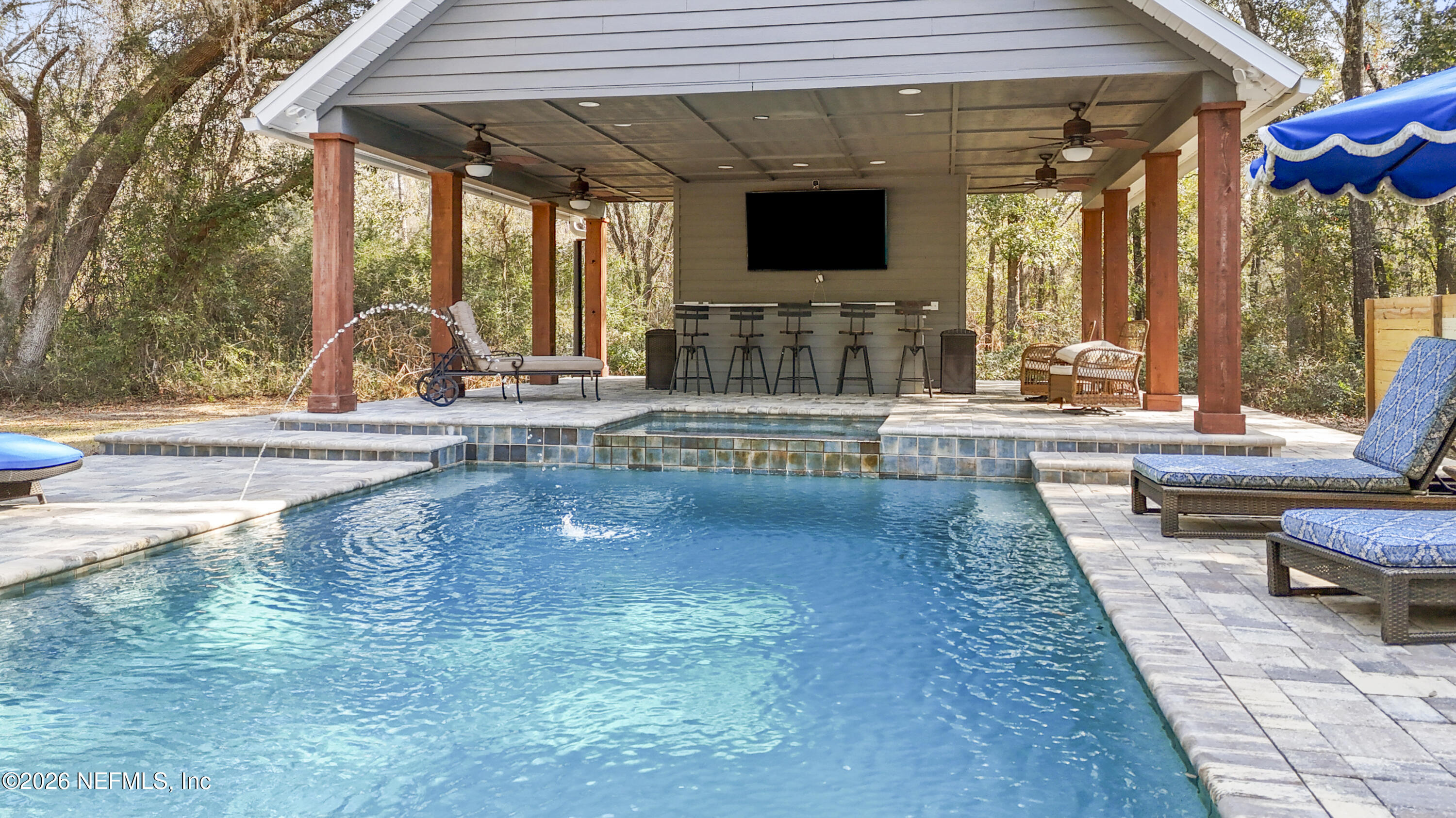 6153 Tim Crews Road Macclenny, FL 32063 - Photo 12 of 79 a swimming pool with outdoor seating and yard