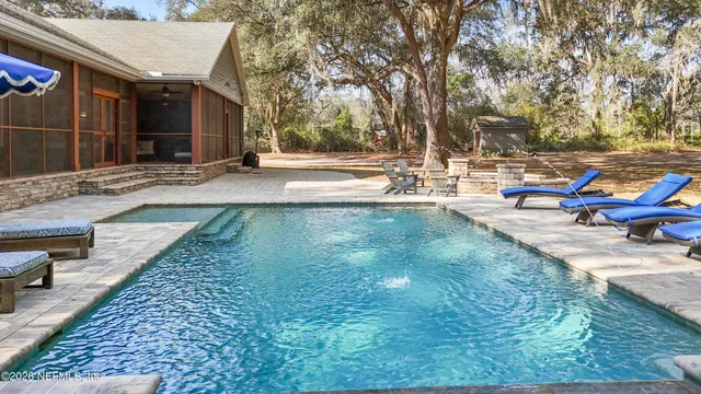 a front view of residential houses with yard and trees