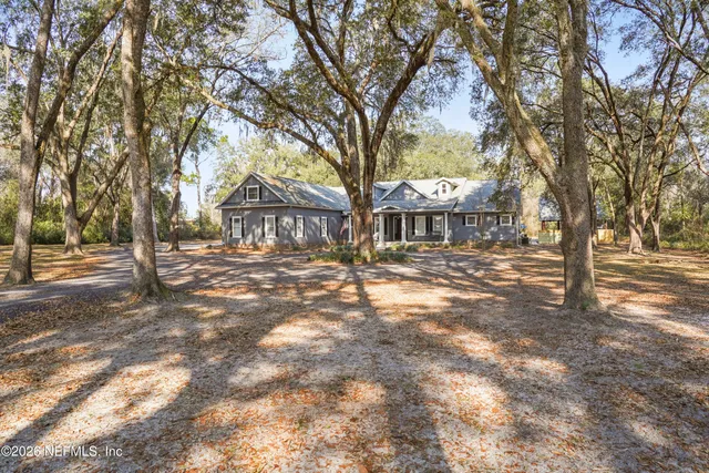 a living room with patio furniture and a flat screen tv