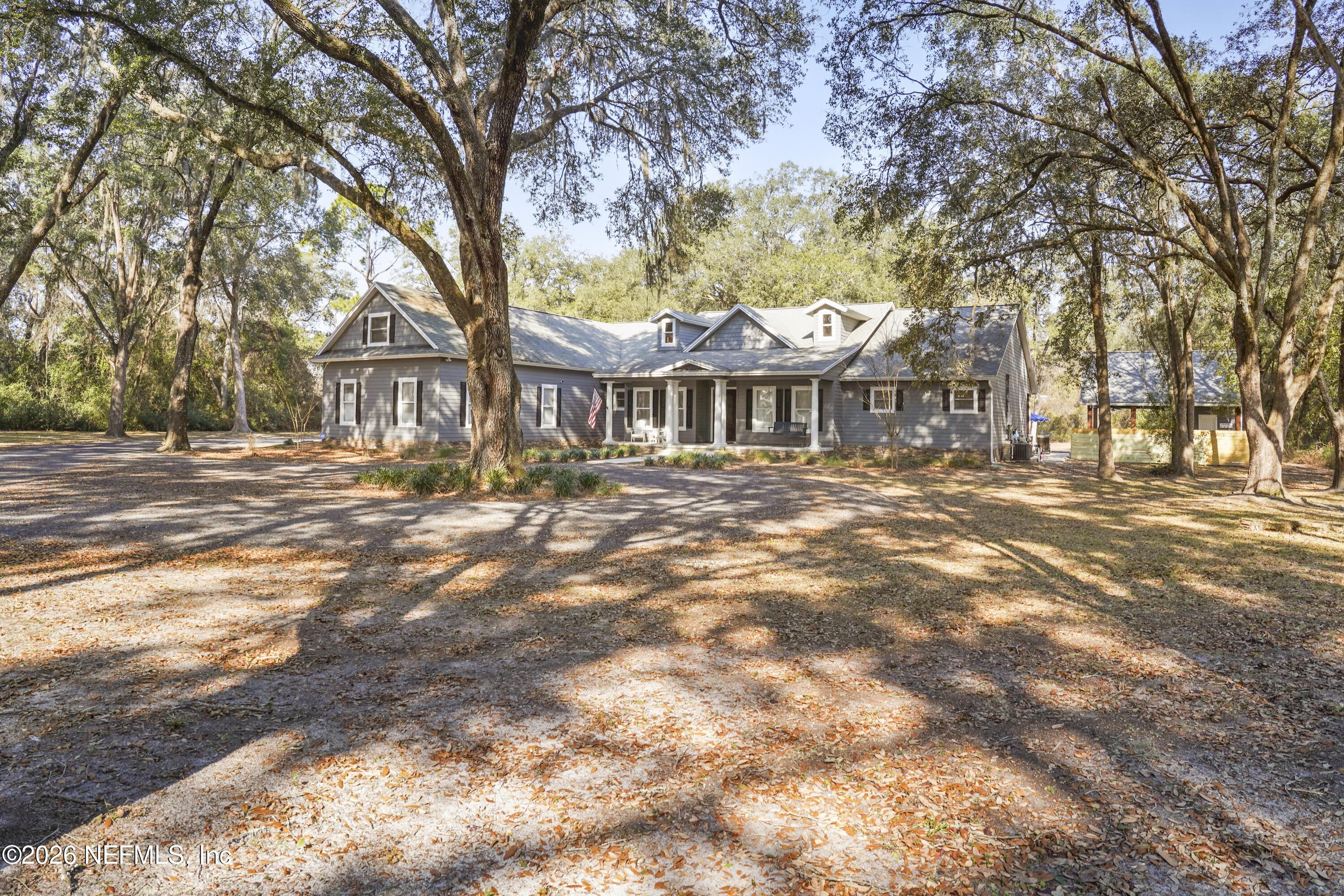 6153 Tim Crews Road Macclenny, FL 32063 - Photo 18 of 79 a front view of a residential apartment building with a yard