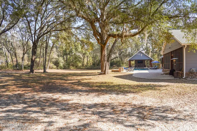a living room with a fireplace a flat screen tv and a view of bookshelf