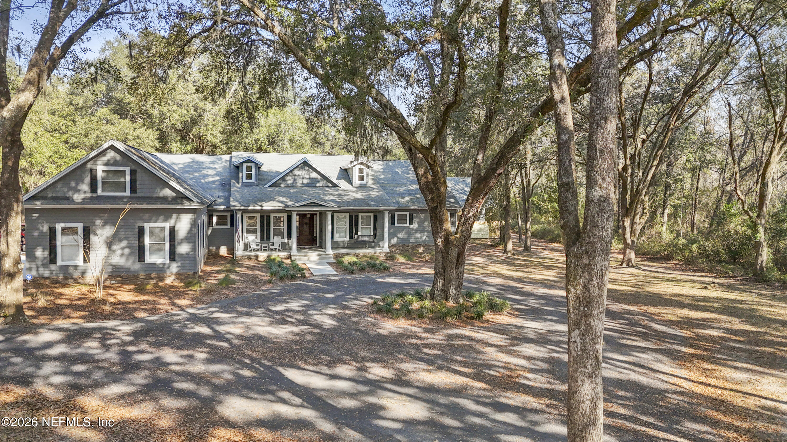 6153 Tim Crews Road Macclenny, FL 32063 - Photo 3 of 79 a front view of a house with a garden