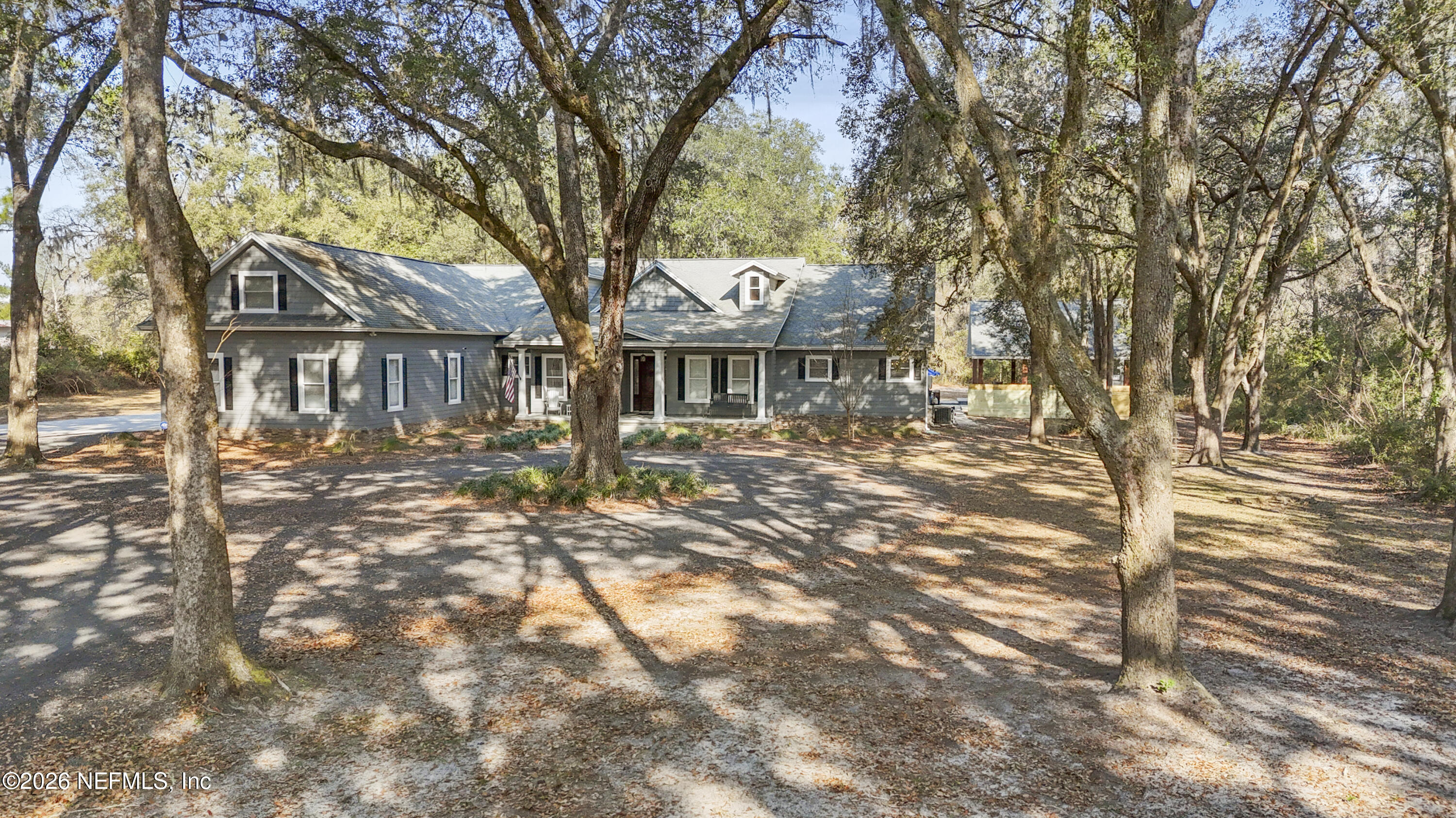 6153 Tim Crews Road Macclenny, FL 32063 - Photo 4 of 79 a front view of a house with a yard