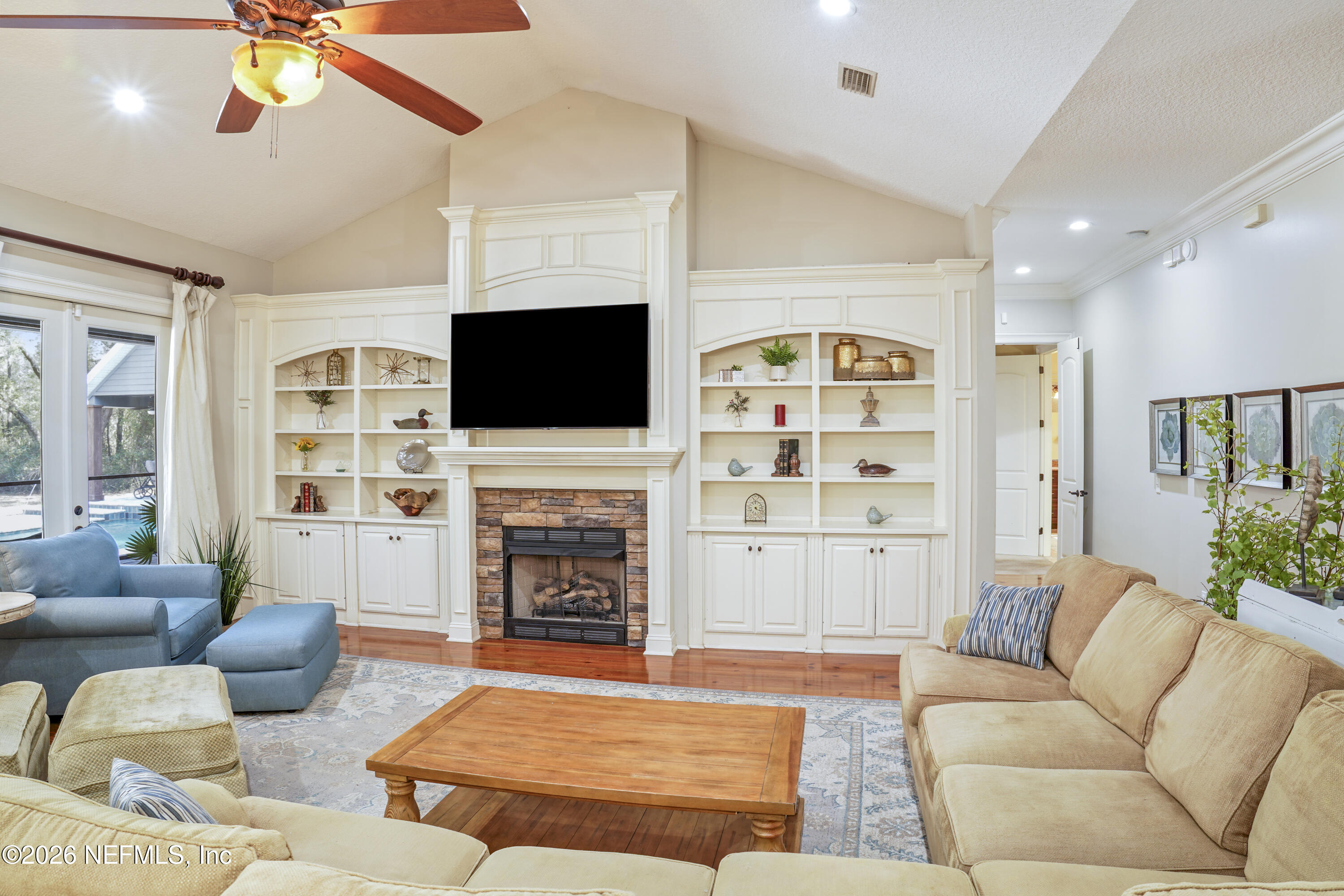 6153 Tim Crews Road Macclenny, FL 32063 - Photo 42 of 79 a living room with furniture a flat screen tv and a fireplace